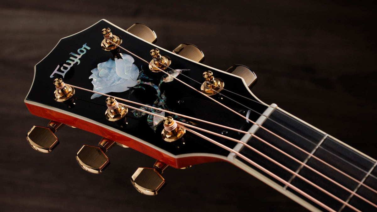 Đàn guitar acoustic điện Taylor Doyle Dykes Signature Model màu Translucent Orange – cận đầu đàn và logo Taylor