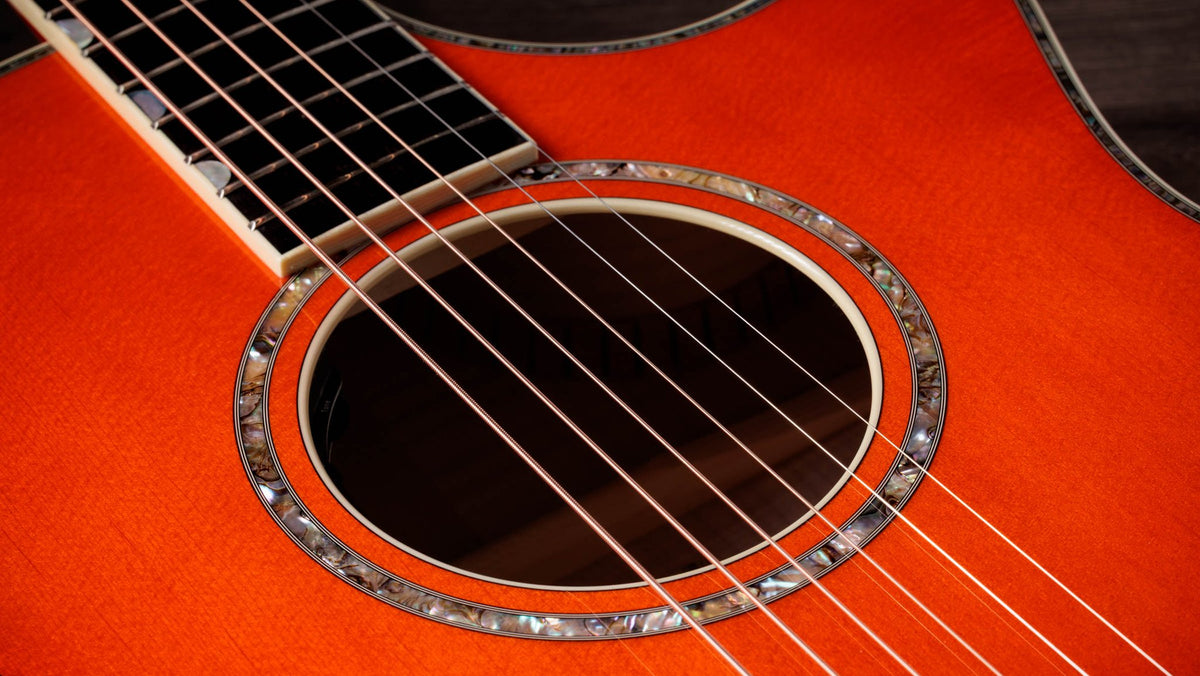 Đàn guitar acoustic điện Taylor Doyle Dykes Signature Model màu Translucent Orange – cận lỗ thoát âm và ngựa đàn