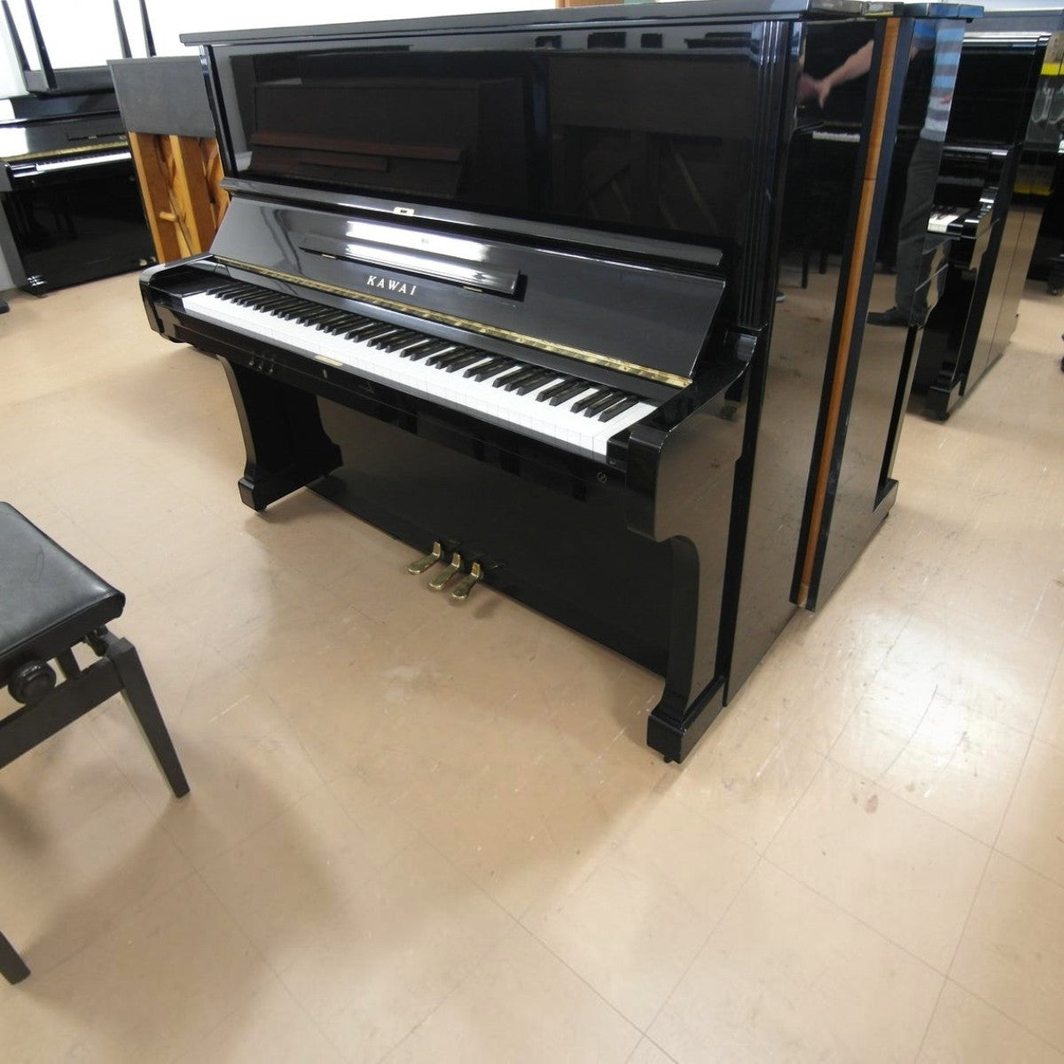 Đàn piano cơ upright Kawai KU3 màu đen bóng sang trọng tại TÂN NHẠC CỤ, thiết kế cổ điển với 3 pedal.
