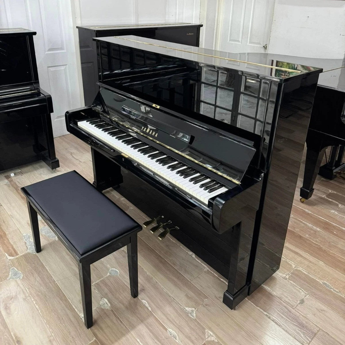 Đàn piano cơ Yamaha U2A màu đen bóng sang trọng tại TÂN NHẠC CỤ, thiết kế upright cổ điển với ghế đàn đi kèm.