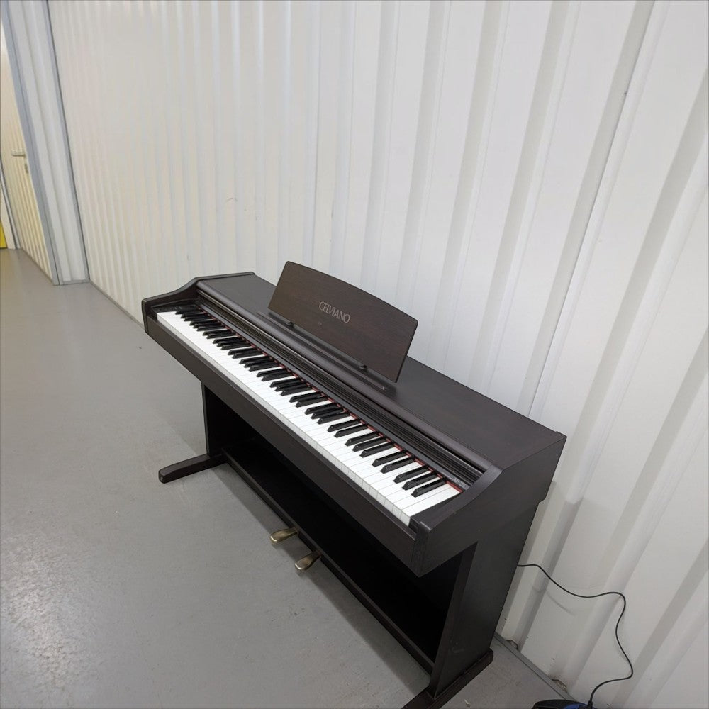 Đàn piano điện TÂN NHẠC CỤ Casio AP25 dáng tủ màu nâu gỗ với 88 phím búa, thiết kế Celviano sang trọng.