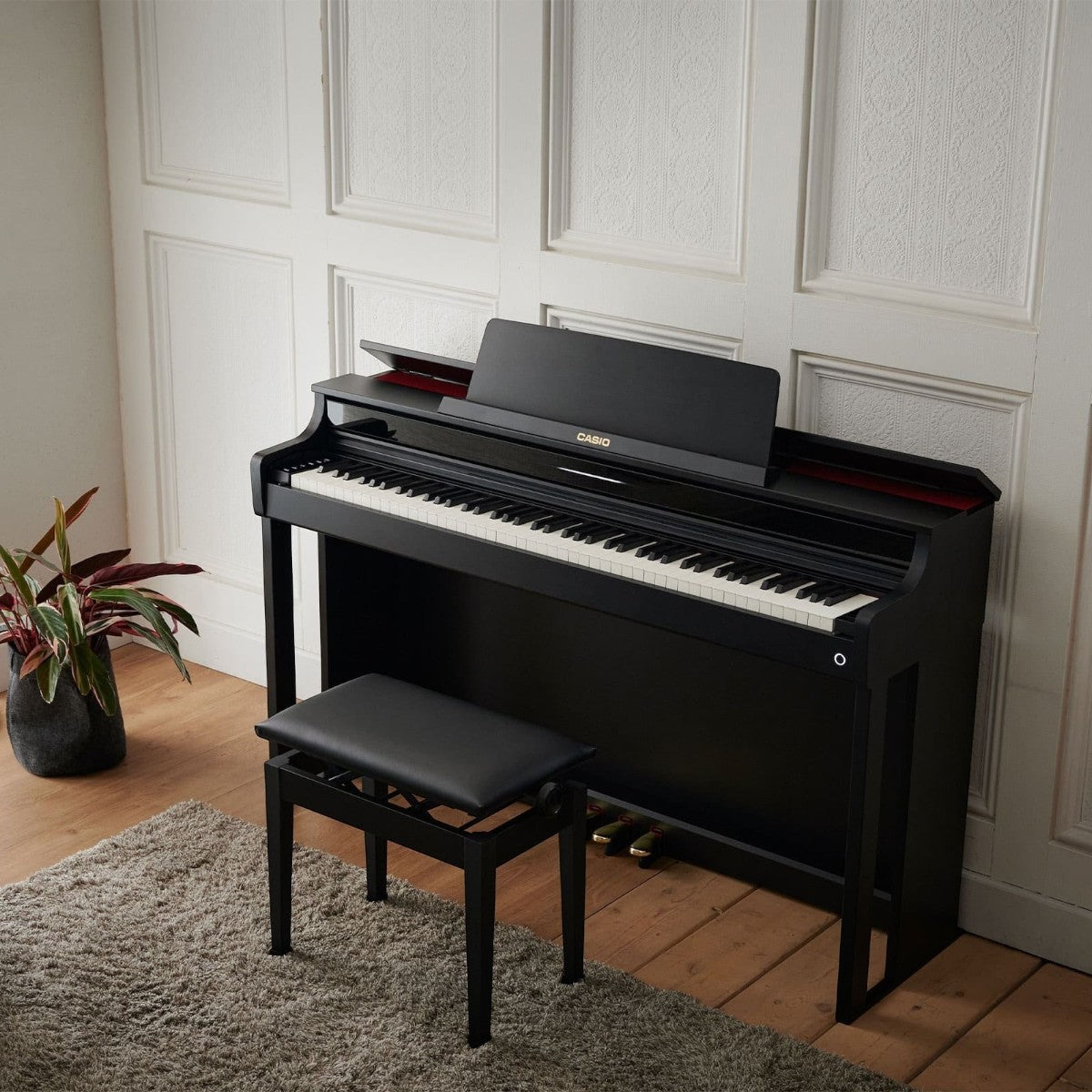 Đàn piano điện Casio AP-550 màu đen sang trọng tại TÂN NHẠC CỤ, thiết kế dáng tủ với nắp mở và ghế đàn đi kèm.