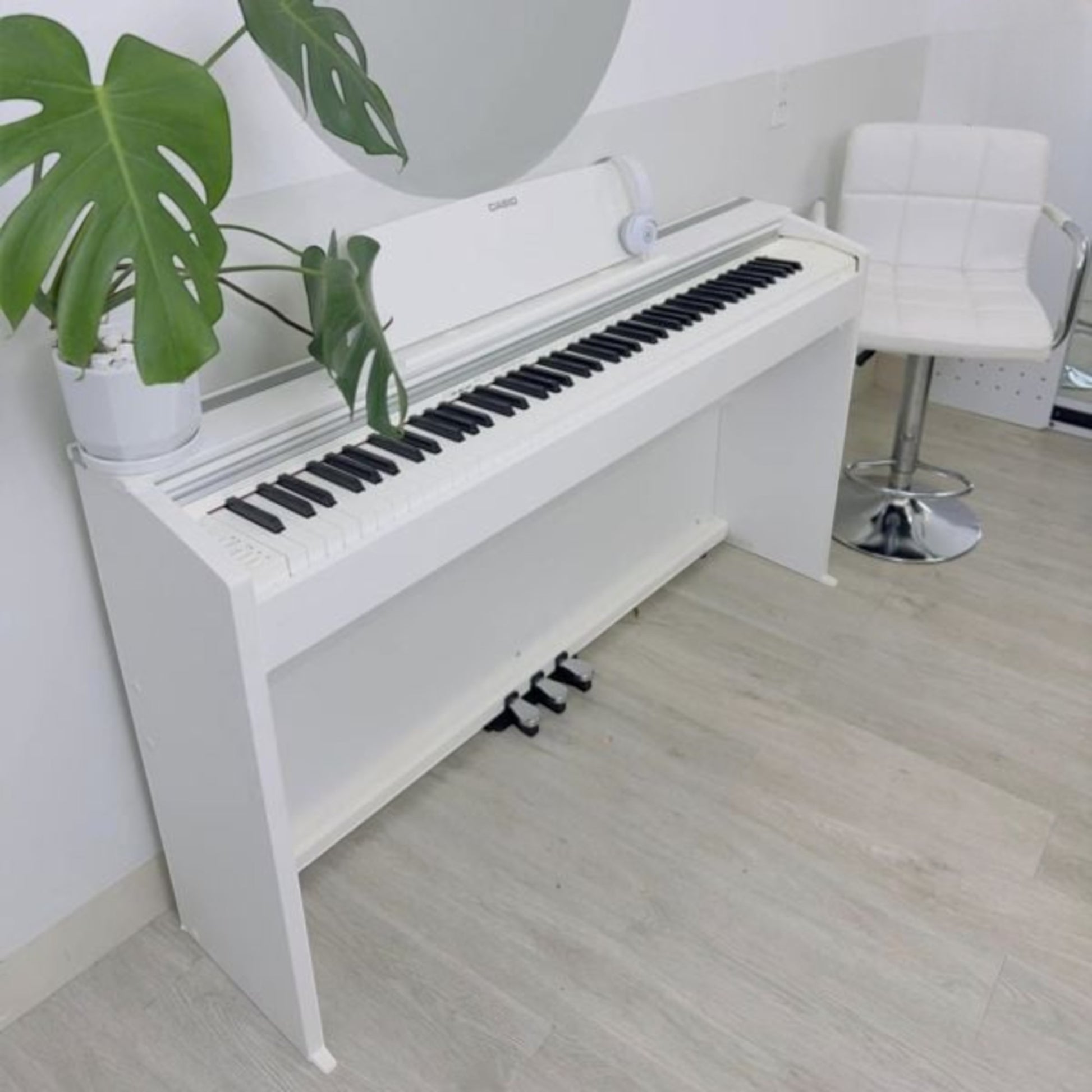 Đàn piano điện TÂN NHẠC CỤ Casio PX2000GP màu trắng hiện đại, thiết kế nhỏ gọn với 88 phím, đặt trong không gian nội thất.
