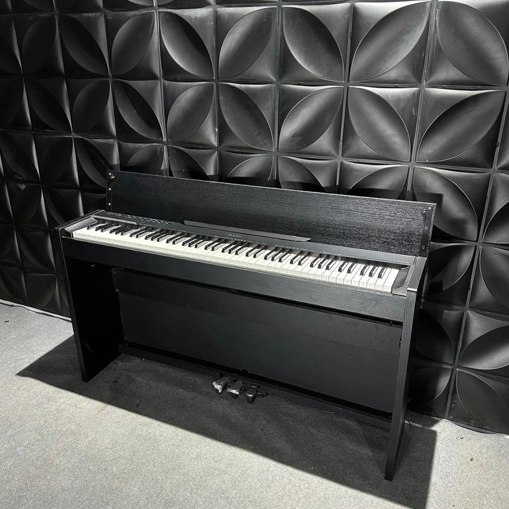 Đàn piano điện TÂN NHẠC CỤ Casio PX830 màu đen dáng tủ với bàn phím 88 phím búa, đặt trước tường ốp trang trí.