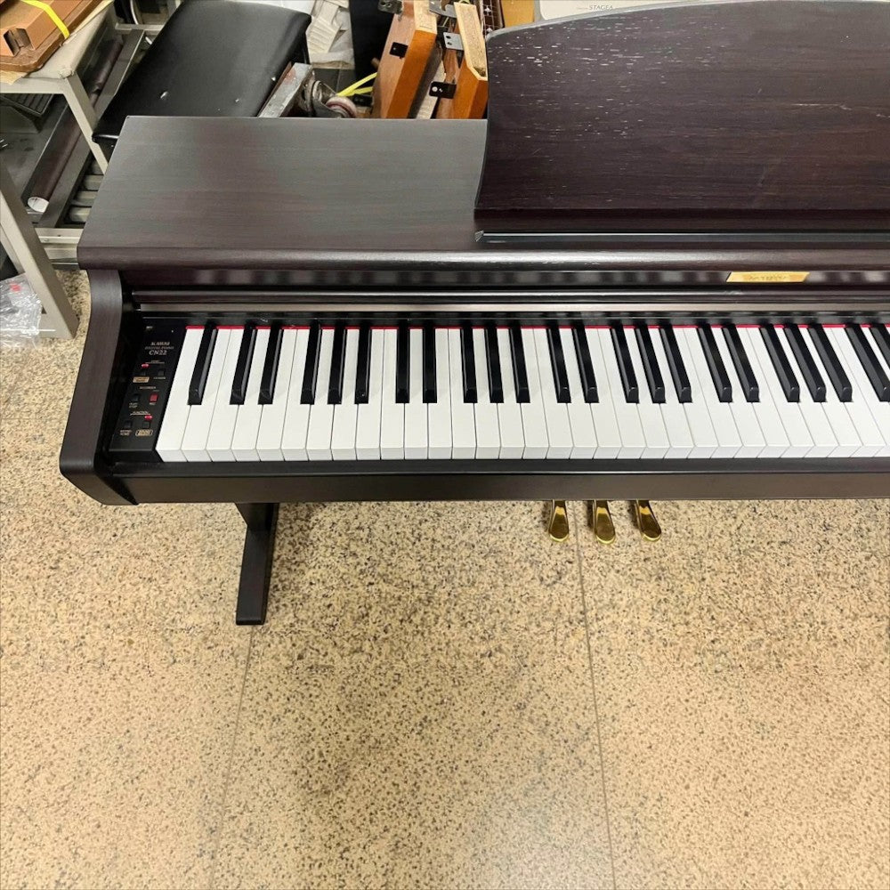 Đàn piano điện TÂN NHẠC CỤ Kawai CN22 dáng tủ màu nâu gỗ với bàn phím 88 phím búa Ivory Touch đã qua sử dụng