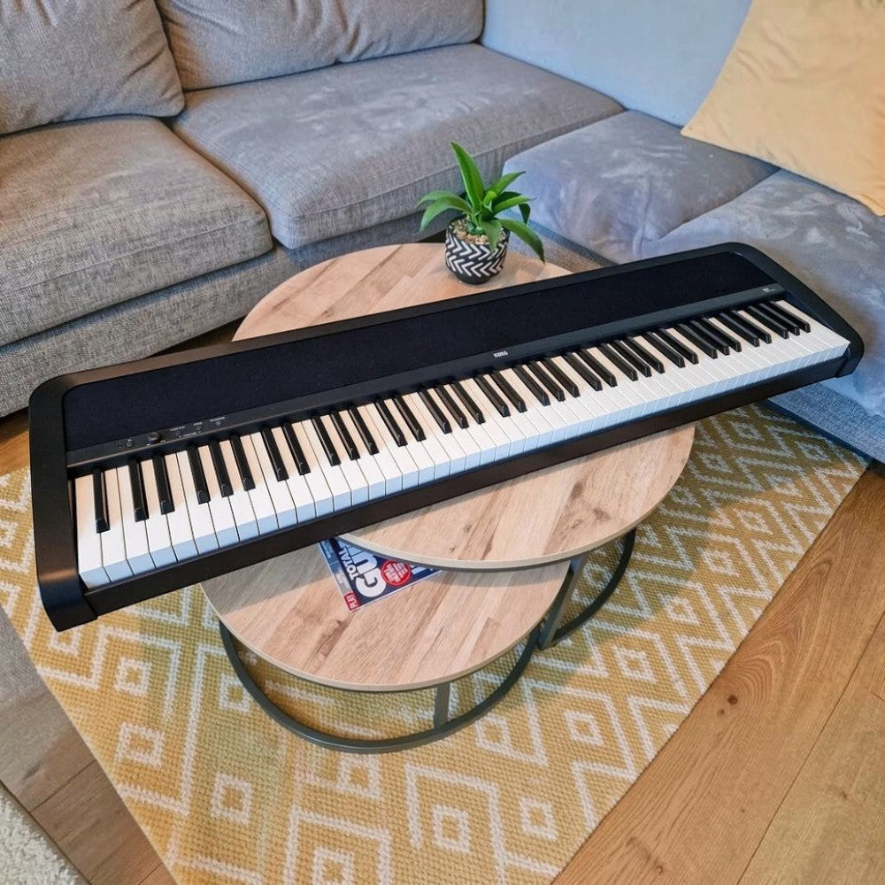 Đàn piano điện Korg B2 màu đen thiết kế gọn nhẹ, đặt trên bàn gỗ trong phòng khách tại TÂN NHẠC CỤ