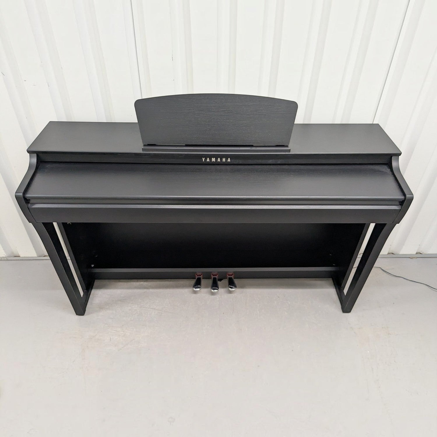 Đàn piano điện Yamaha CLP725 màu đen sang trọng tại TÂN NHẠC CỤ, thiết kế dáng tủ hiện đại với 3 pedal.