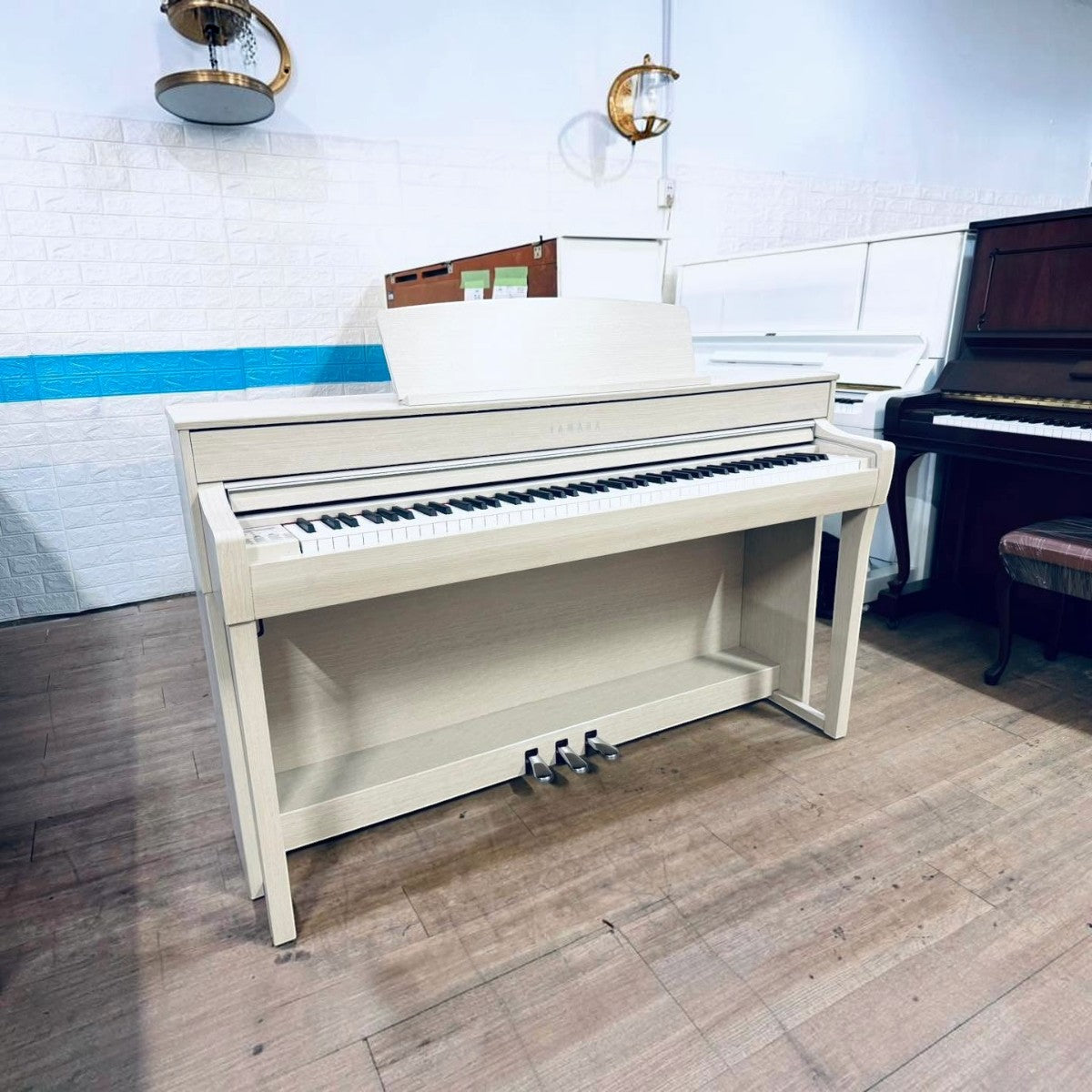 Đàn piano điện Yamaha CLP-745 màu trắng tại Tân Nhạc Cụ, thiết kế dáng tủ sang trọng với bàn phím gỗ GrandTouch-S.