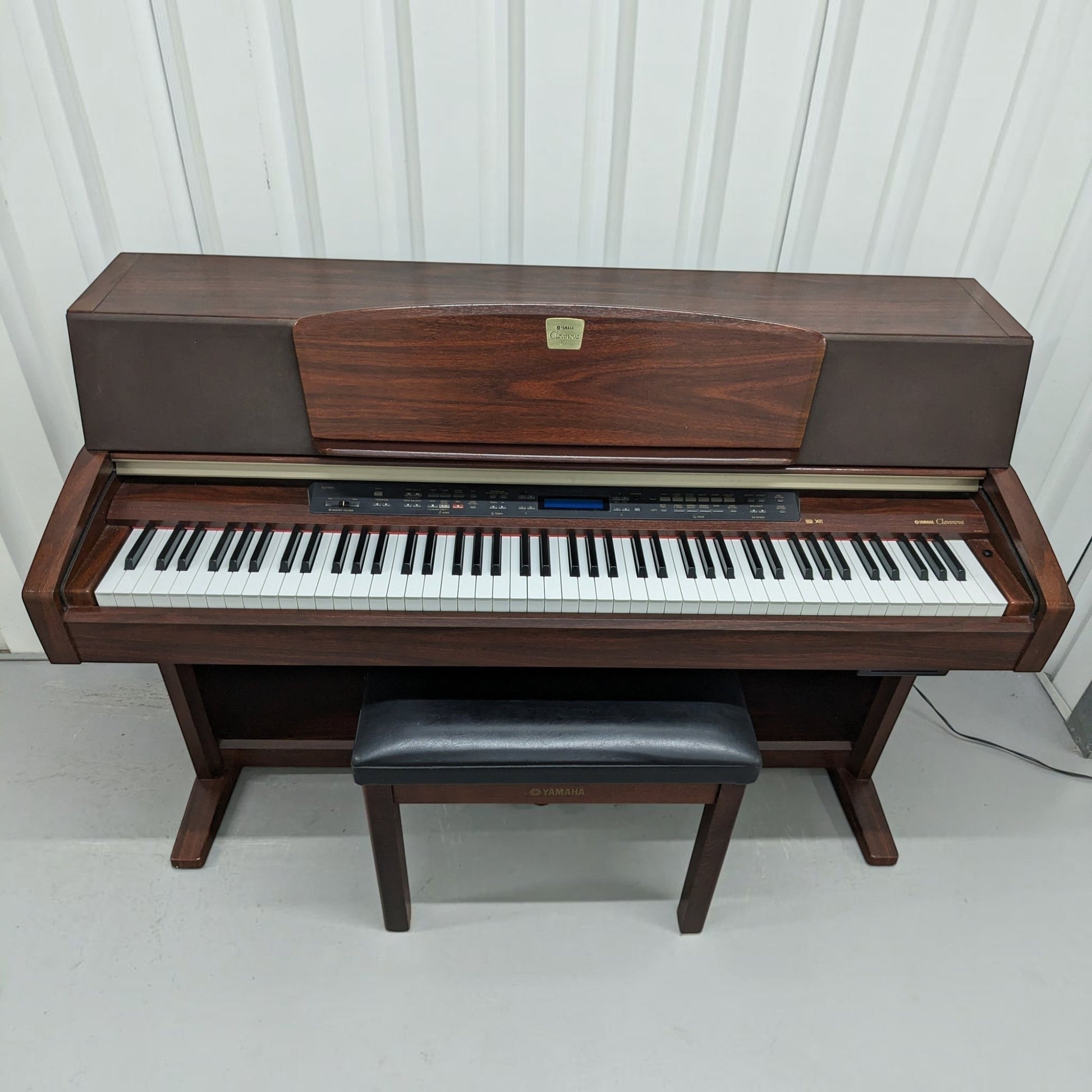 Đàn piano điện Yamaha CLP-970 màu gỗ sang trọng tại Tân Nhạc Cụ với thiết kế dáng tủ cổ điển và ghế ngồi đi kèm