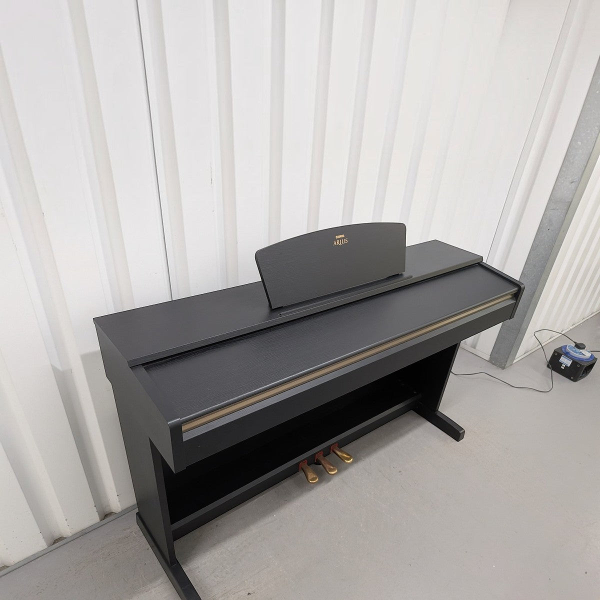 Đàn piano điện Yamaha YDP-161 màu đen sang trọng tại Tân Nhạc Cụ với thiết kế dáng tủ chắc chắn và 3 pedal vàng