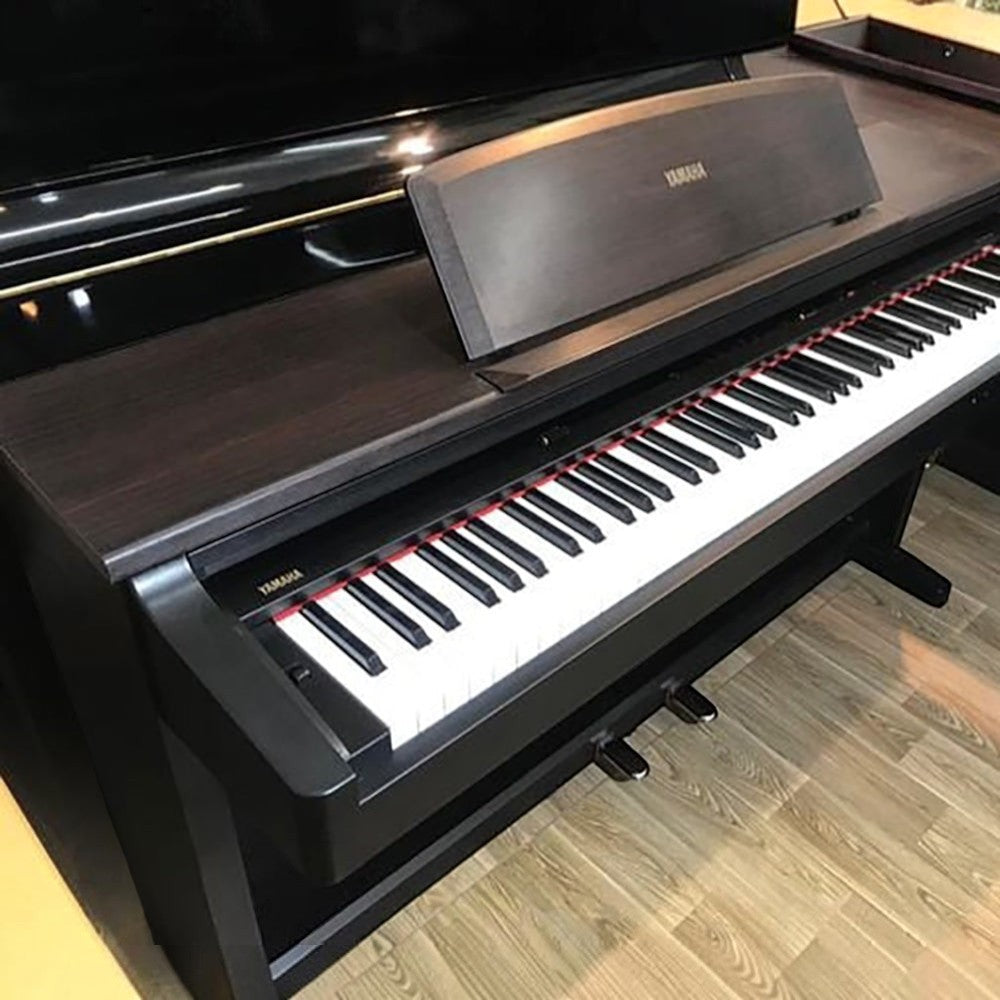 Đàn piano điện TÂN NHẠC CỤ Yamaha YDP300 cũ màu đen vân gỗ, dáng tủ với 88 phím búa GH và 3 pedal.