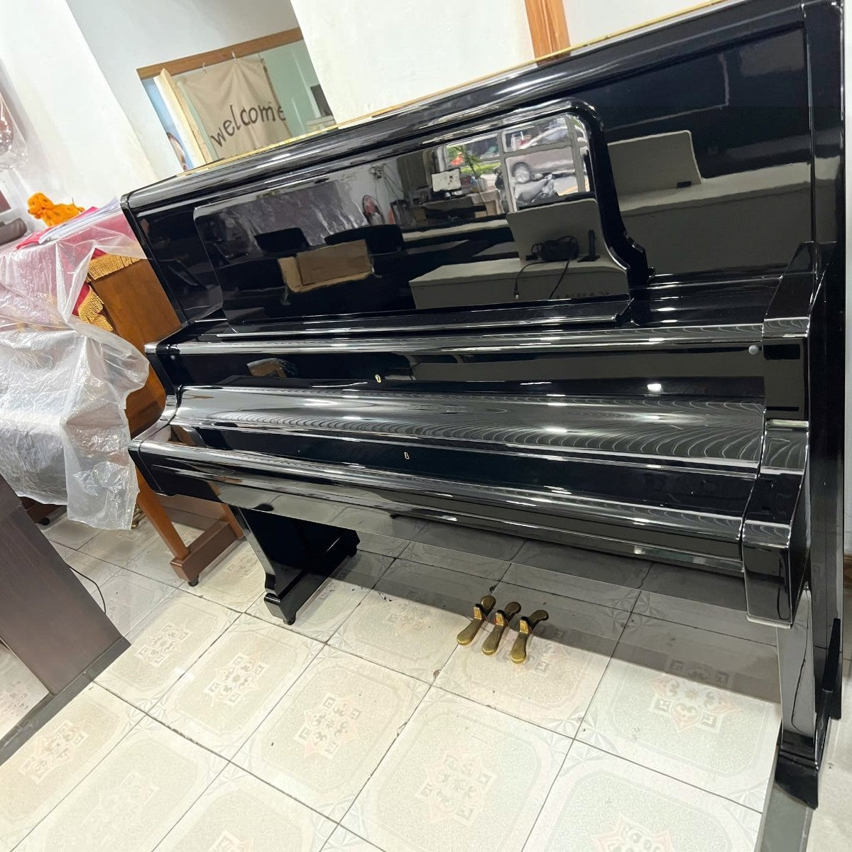 Đàn piano cơ upright Kawai US50 màu đen bóng sang trọng tại Tân Nhạc Cụ với thiết kế cao cấp và ba pedal vàng