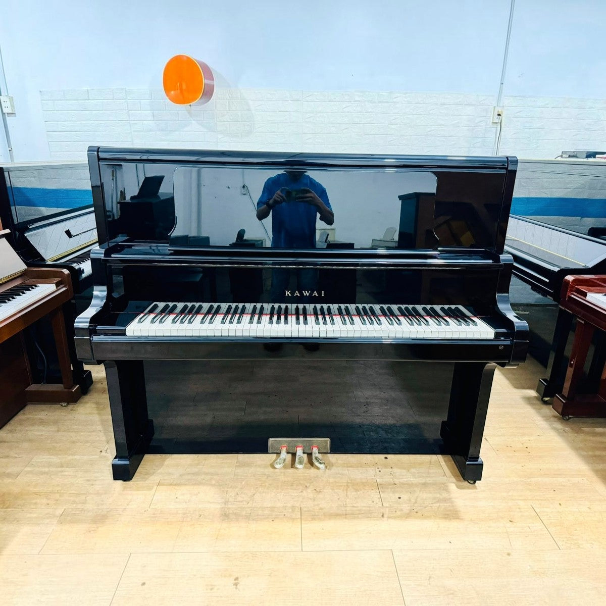 Đàn piano cơ upright Kawai US7X màu đen bóng sang trọng tại TÂN NHẠC CỤ, thiết kế cao cấp với mặt phím ngà nhân tạo.