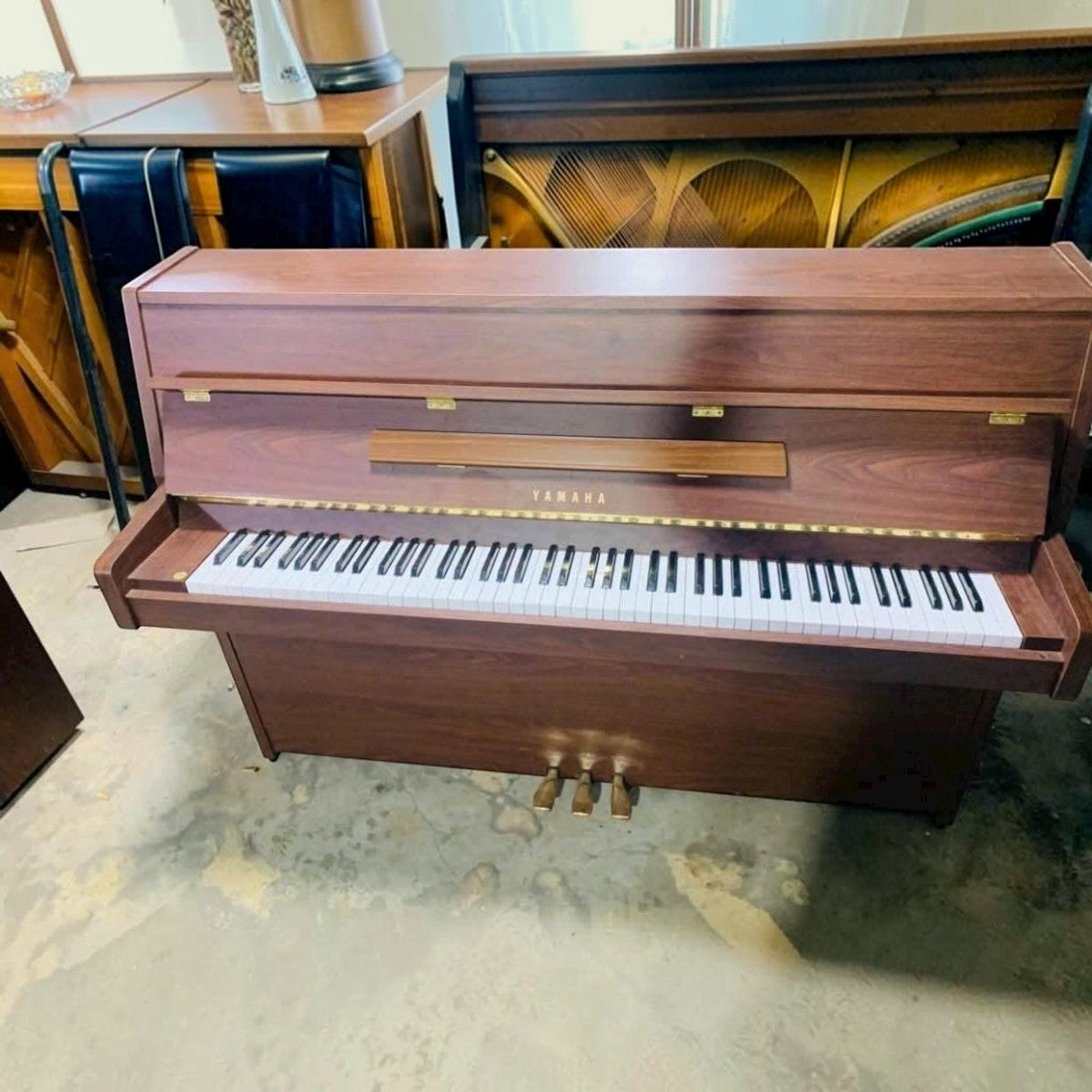 Đàn piano cơ Yamaha MC101 vân gỗ Mahogany sang trọng tại Tân Nhạc Cụ với thiết kế console gọn nhẹ