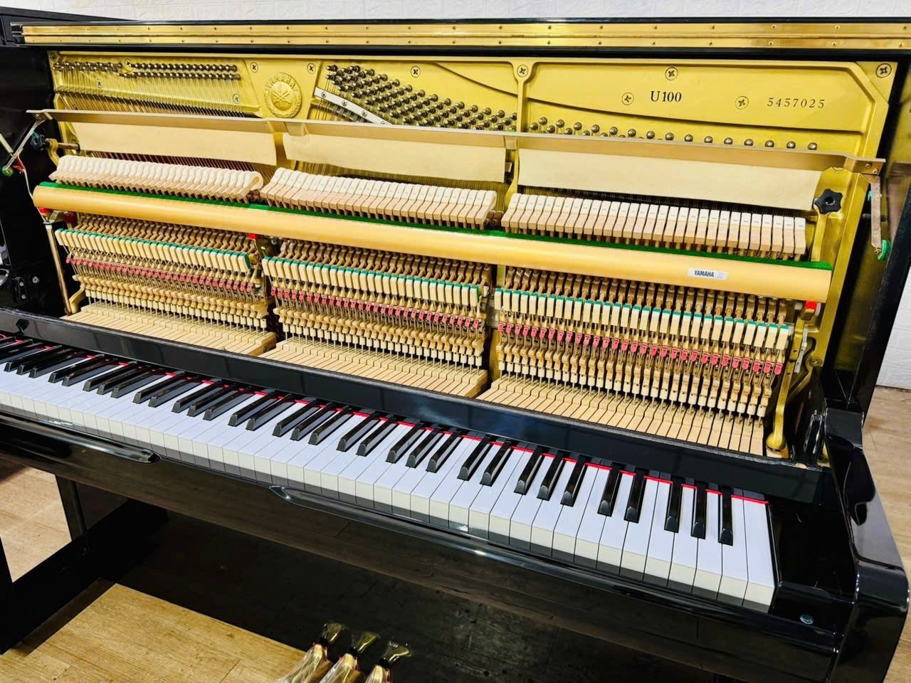 Bên trong đàn piano cơ TÂN NHẠC CỤ Yamaha U100 màu đen bóng với bộ máy, búa đàn và khung gang chi tiết